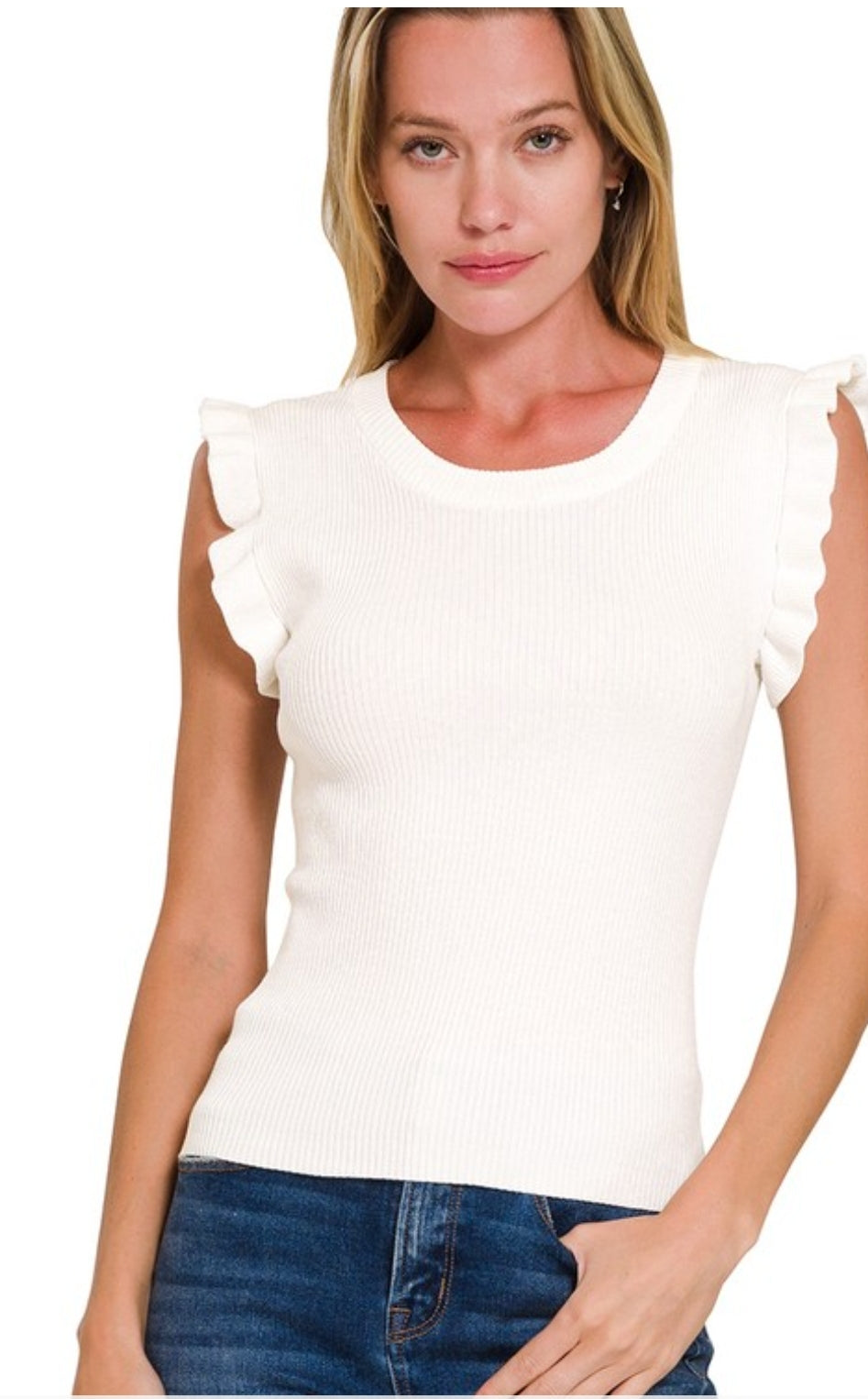 Woman wearing a white ruffled sleeve top against a white background