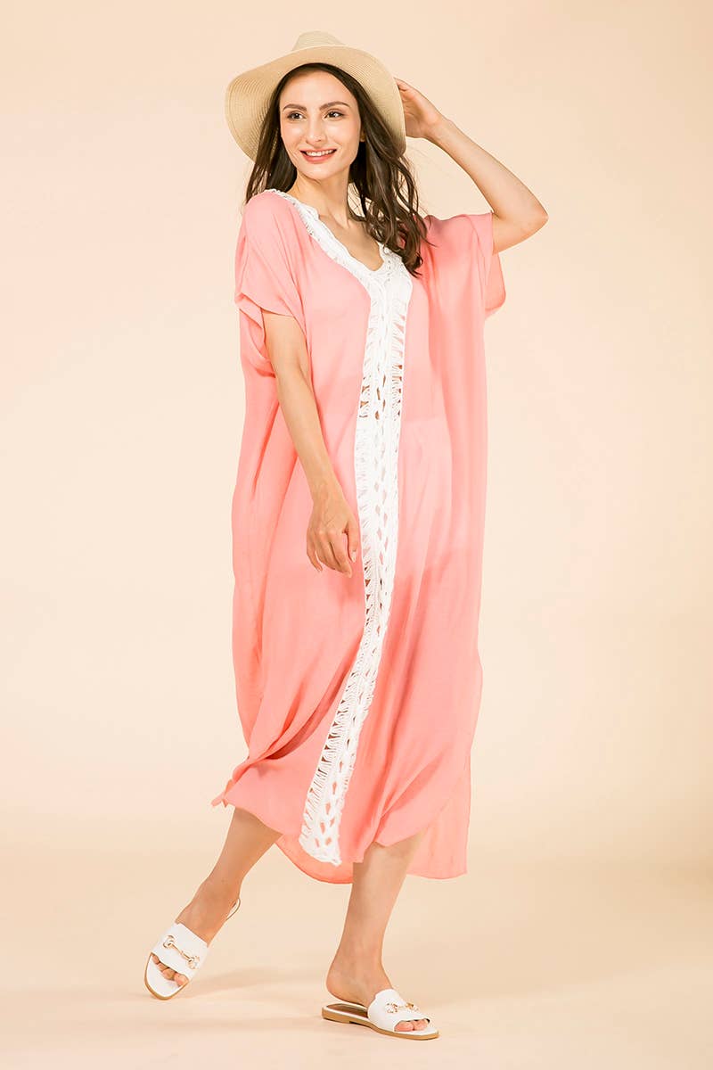 Woman wearing a pink kimono-style garment with white lace trim on a beige background