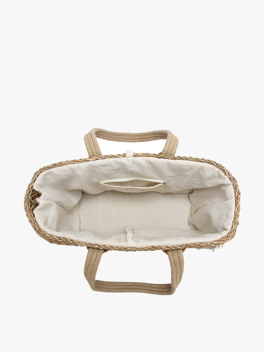 Woven bag with a white interior on a light beige background