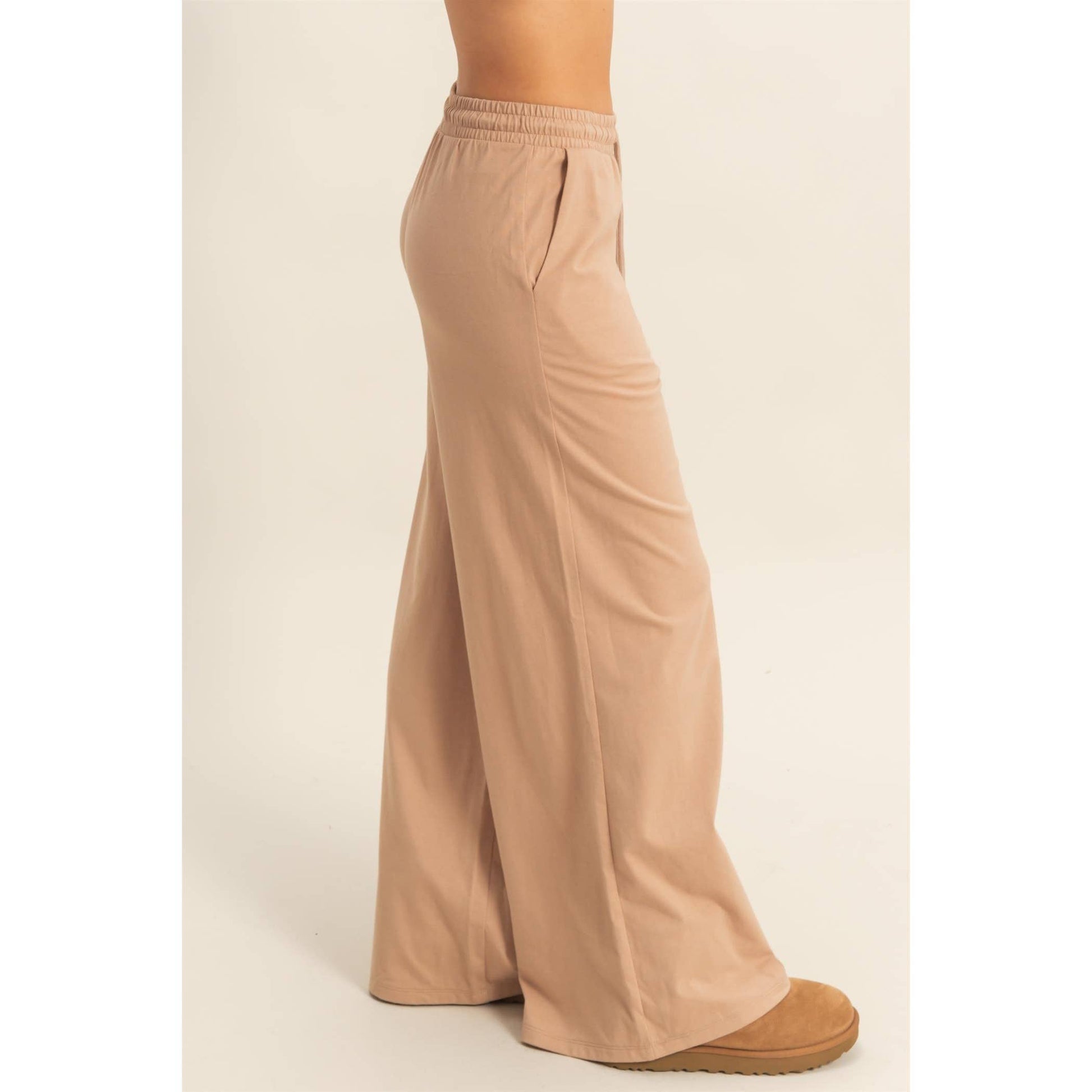 Beige wide-leg pants on a plain background