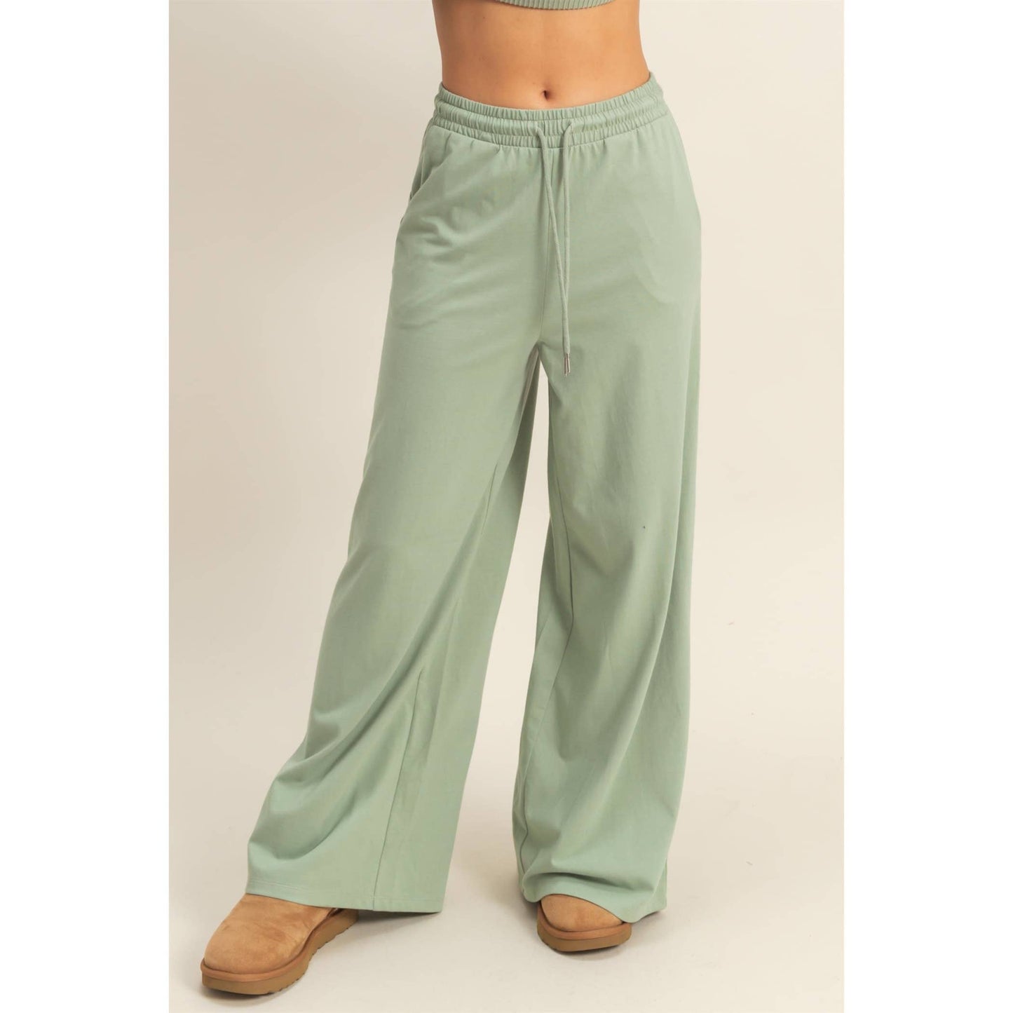 Light green wide-leg pants worn by a person on a plain background