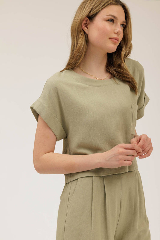 Woman wearing a green outfit against a plain background