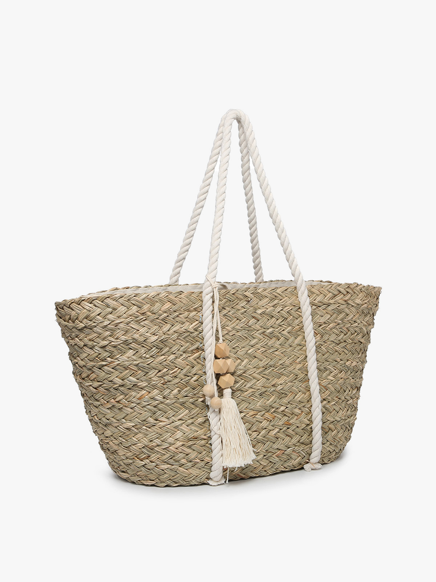Woven straw bag with rope handles and tassel on a white background