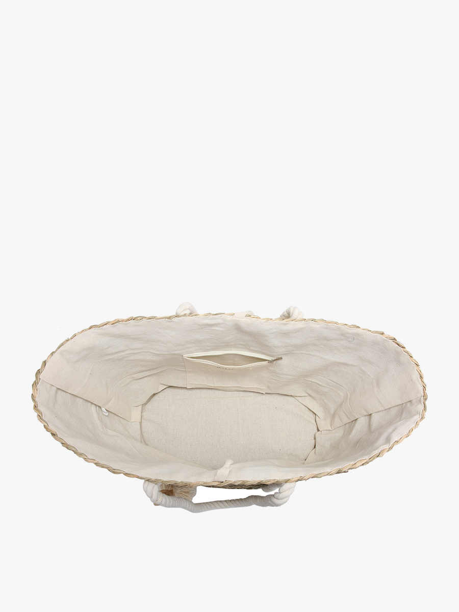 Round beige cushion with scalloped edge on a white background