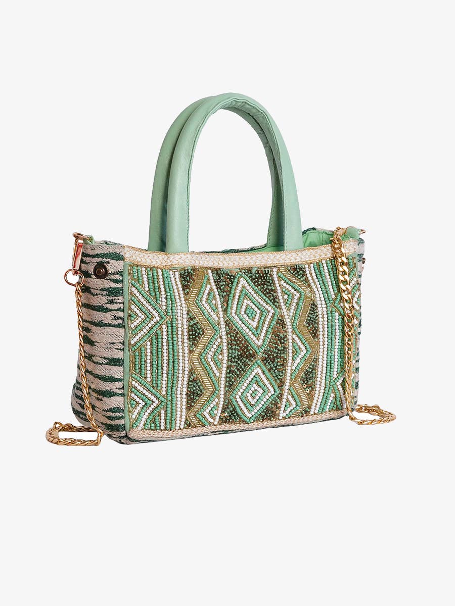 Green handbag with geometric pattern on a white background