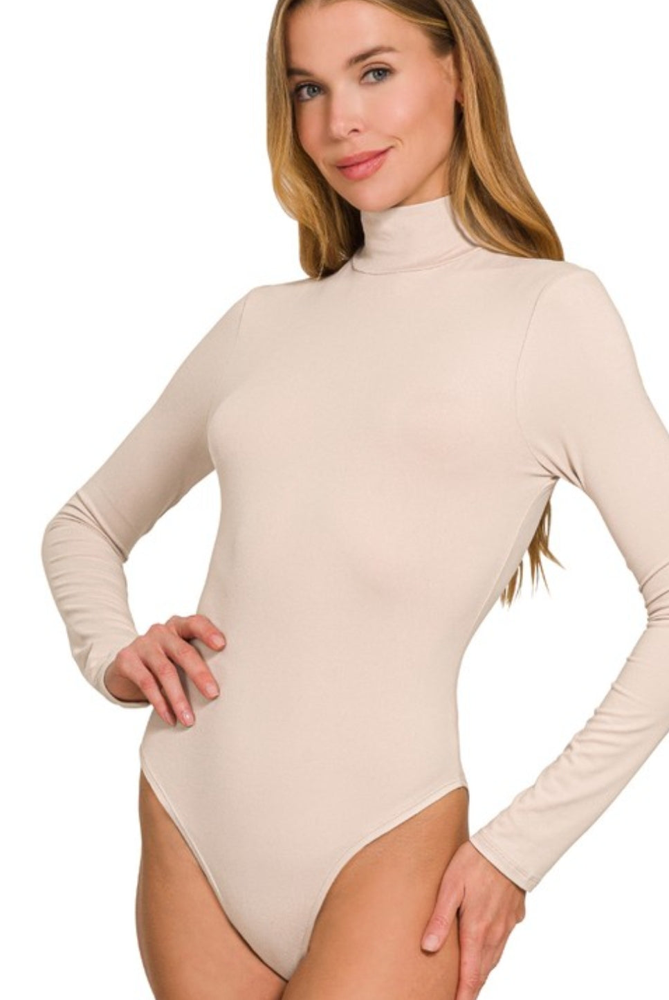 Woman wearing a beige long-sleeve bodysuit on a white background
