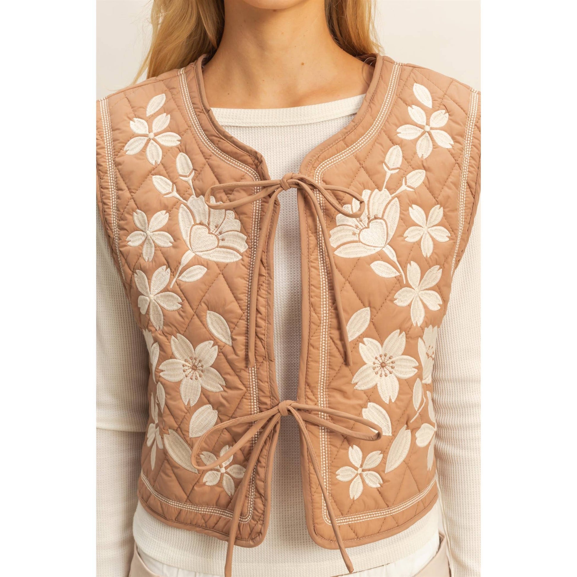 Quilted vest with floral patterns worn by a person